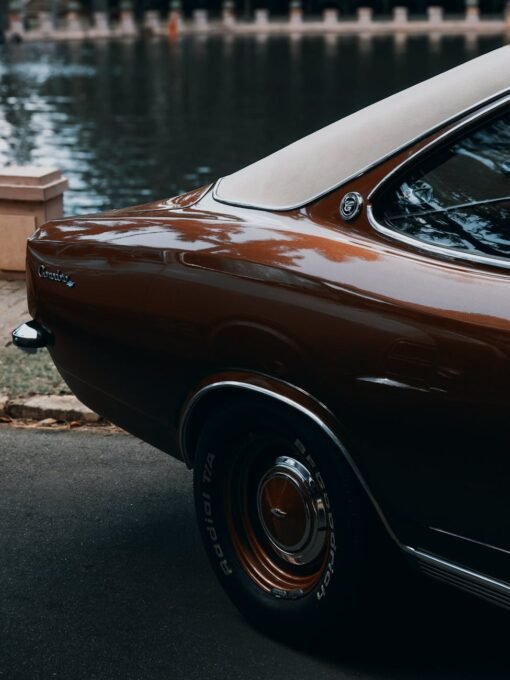 Capture the nostalgia with a vintage car parked by a tranquil lake in Brazil, perfect for classic car enthusiasts.